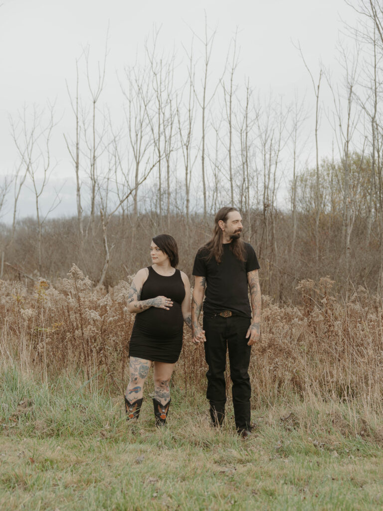 a couple in a field holding hands 