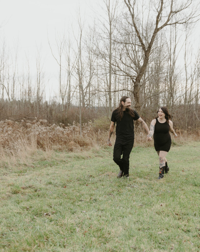 a couples running through a field