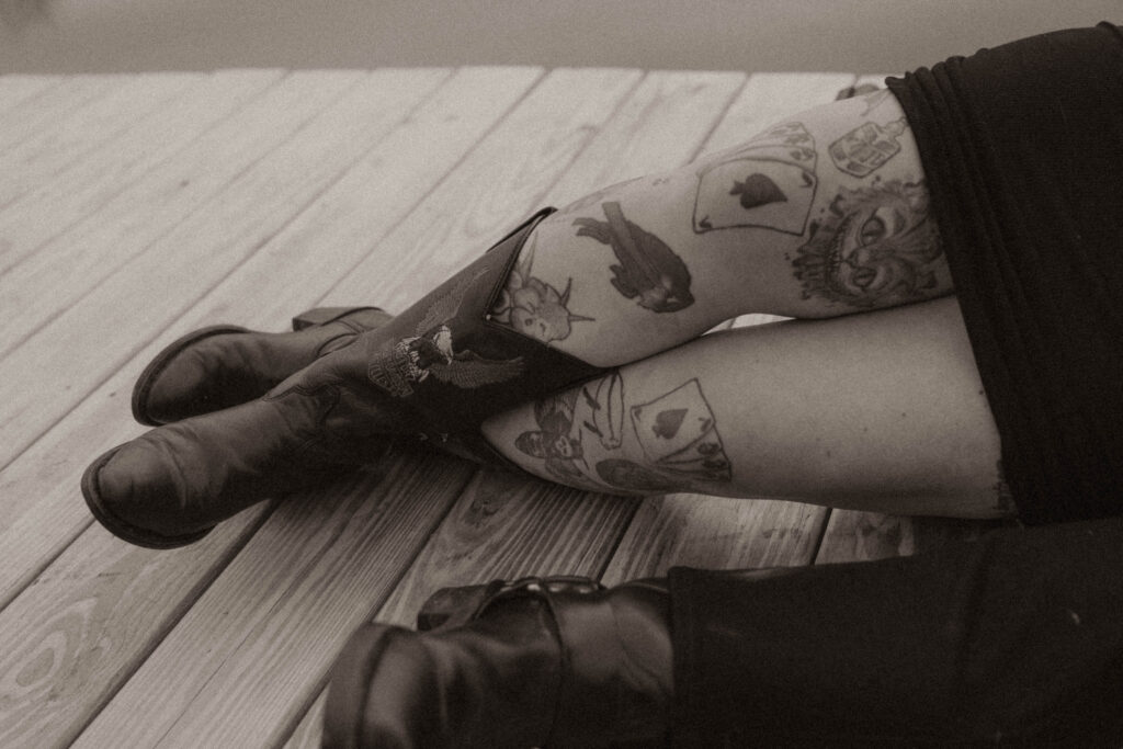 a close up of harley davidson boots and a buffalo bills tattoo 